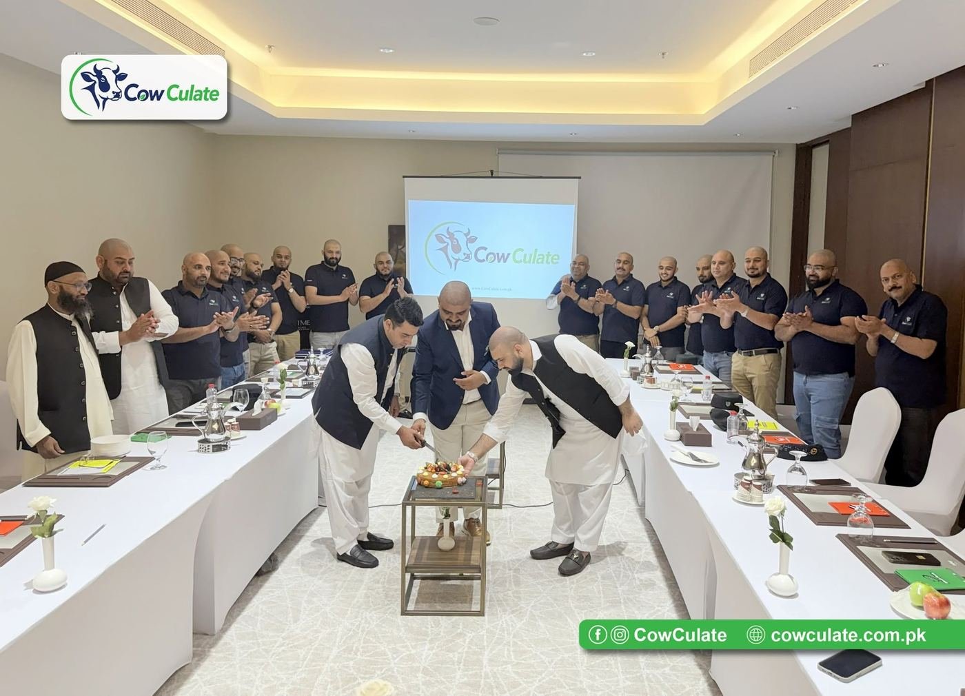The CowCulate team celebrating the company's official launch with a cake-cutting ceremony